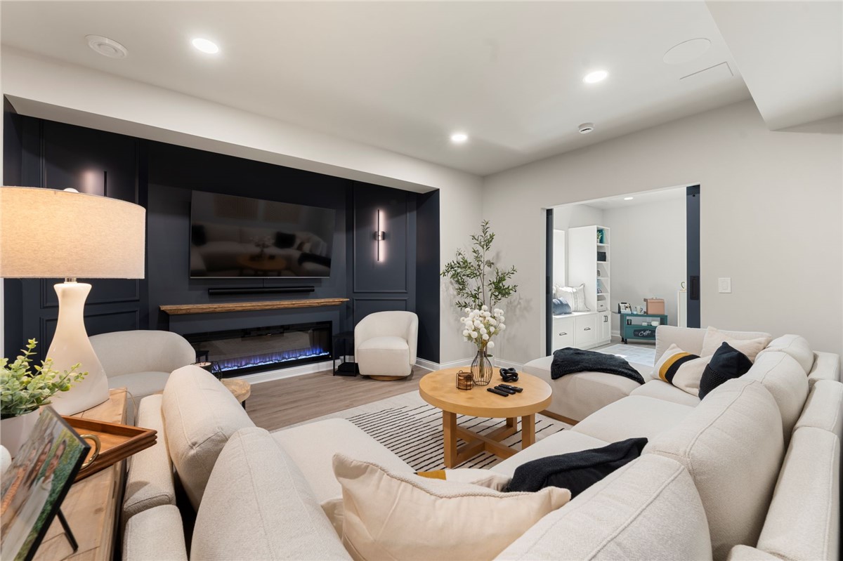 Basement finishing with navy accent wall and electric fireplace
