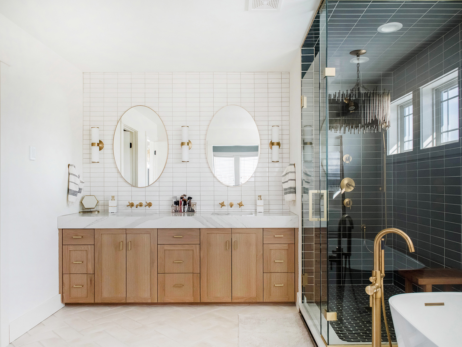 Master bath with wood vanity and custom tile shower